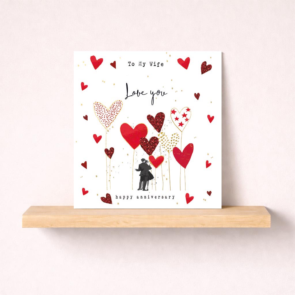 Romantic greetings card with couple surrounded by hearts, perfect for Valentine's Day or anniversary. Ideal for expressing love to a special someone.