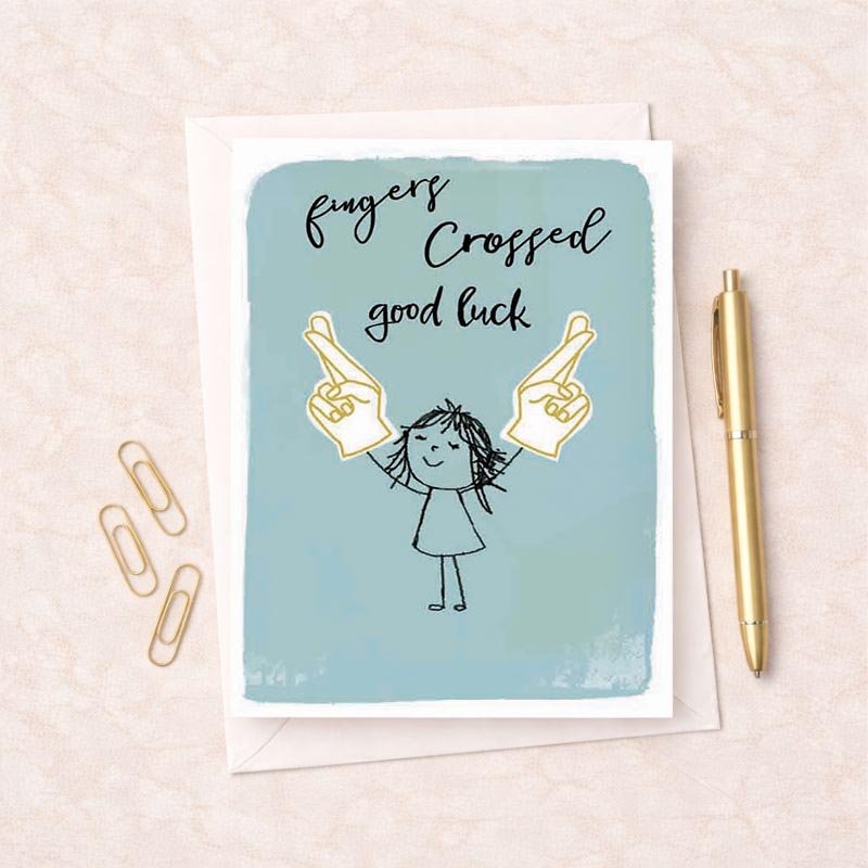 Cheerful greetings card with girl holding up two fingers, saying "fingers crossed, good luck" for positivity and encouragement.