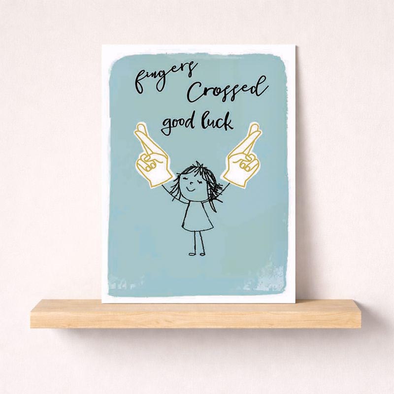 Cheerful greetings card with girl holding up two fingers, saying "fingers crossed, good luck" for positivity and encouragement.