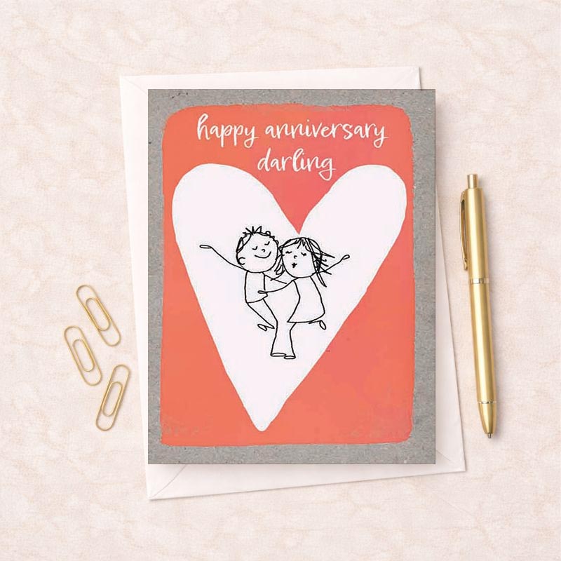 A heartwarming card with a couple hugging in front of a heart, saying "happy anniversary darling". Ideal for expressing love and celebrating special moments.