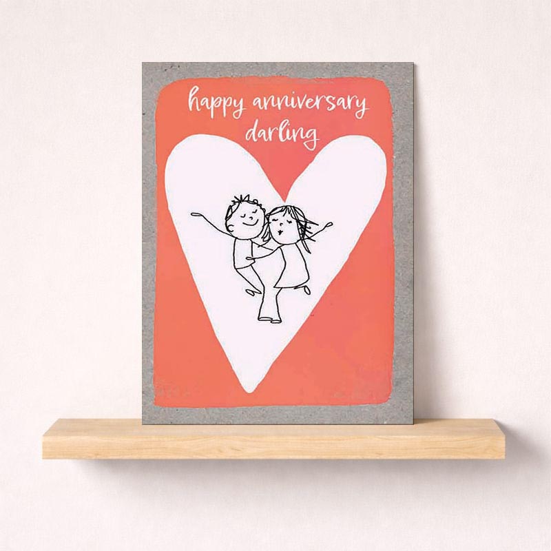 A heartwarming card with a couple hugging in front of a heart, saying "happy anniversary darling". Ideal for expressing love and celebrating special moments.