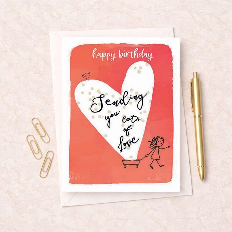 Birthday greetings card with girl pushing cart, heart symbolizing love, "happy birthday Sending you lots Love".