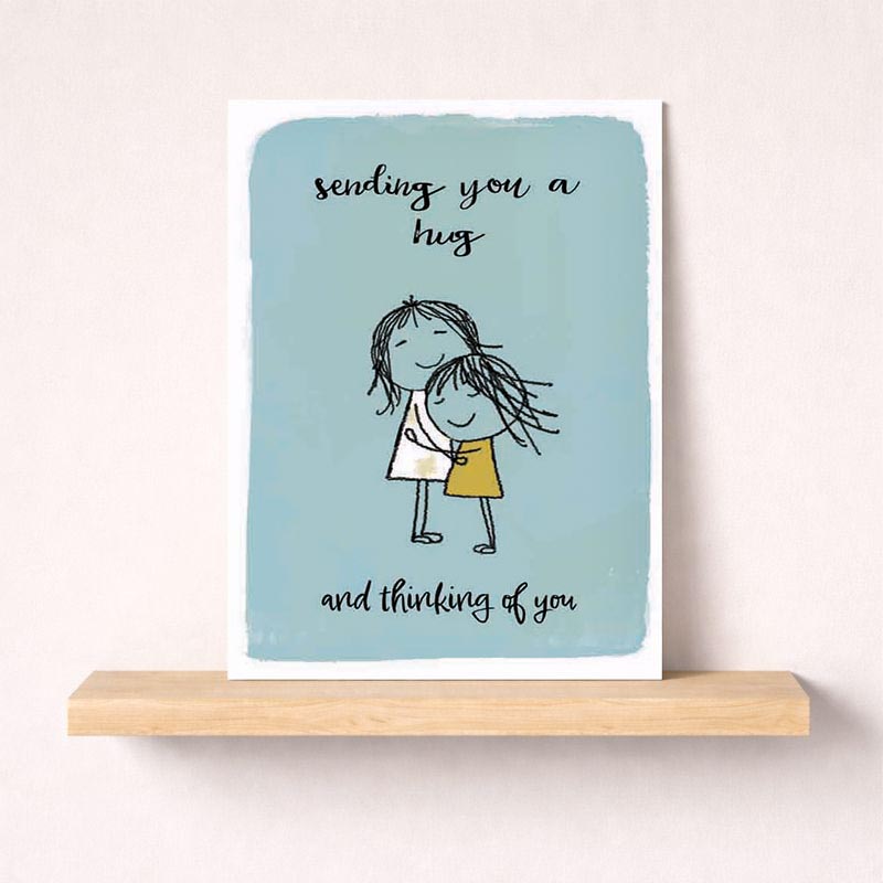 Heartwarming card with girl hugging face, saying "sending you a hug and thinking of you". Ideal for spreading love and comfort.