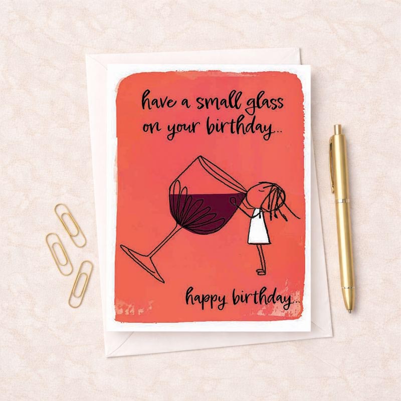 A girl holding a glass of wine on a birthday greetings card.