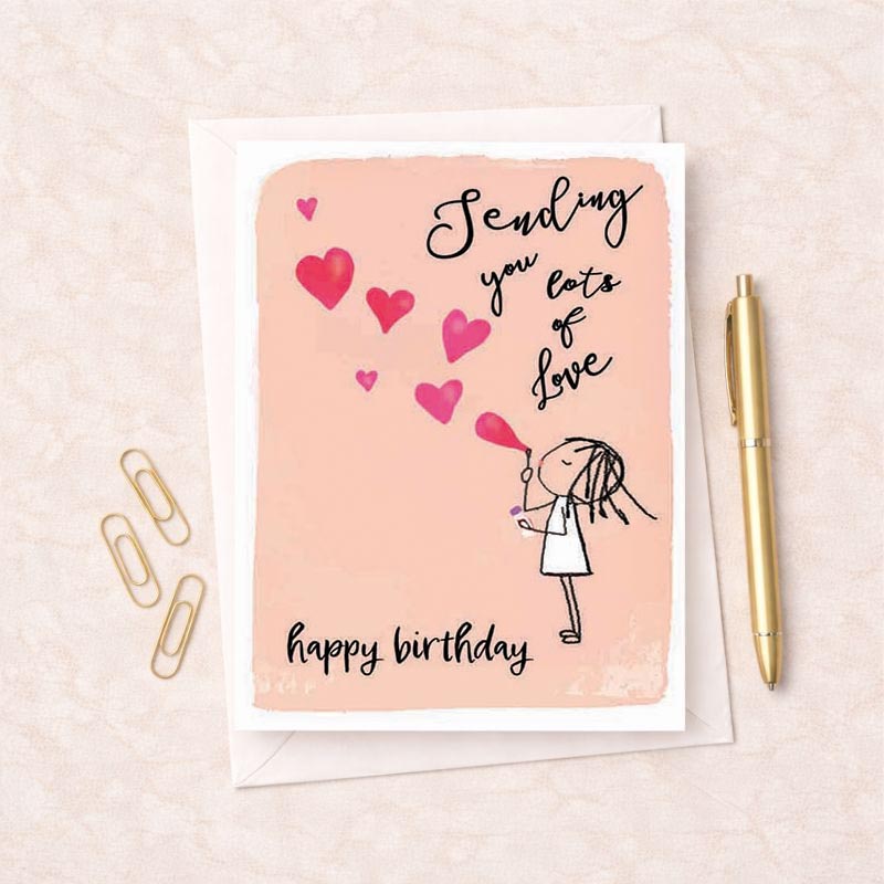 Bright pink birthday card with girl blowing balloon surrounded by hearts. Message: "Sending you lots of Love &amp; happy birthday.