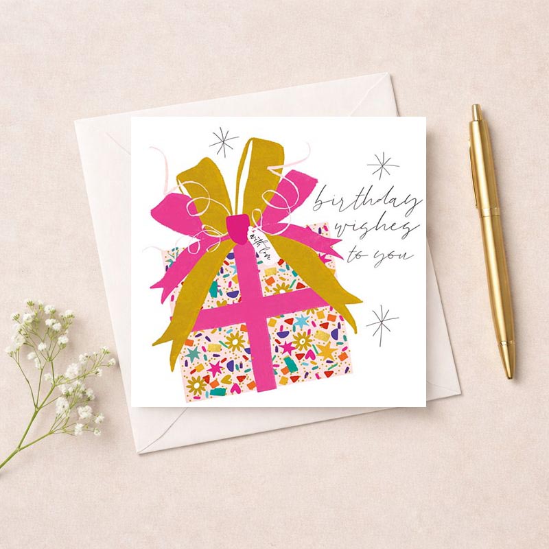 Pink gift on pink background, perfect for spreading joy and love with birthday wishes.