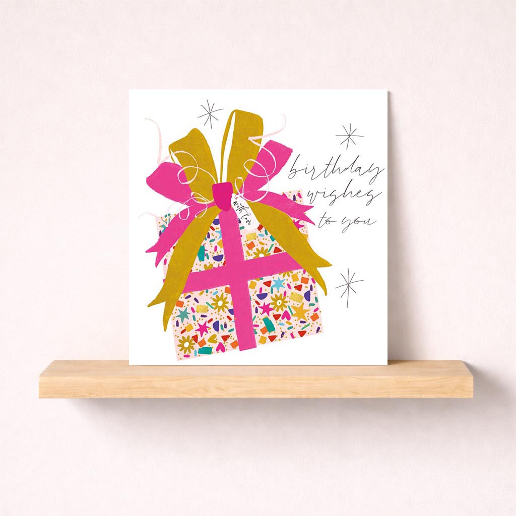 Pink gift on pink background, perfect for spreading joy and love with birthday wishes.
