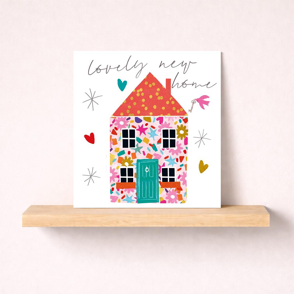 colourful house with pink roof, yellow door, and hearts. Spread love and cheer with this delightful greetings card.